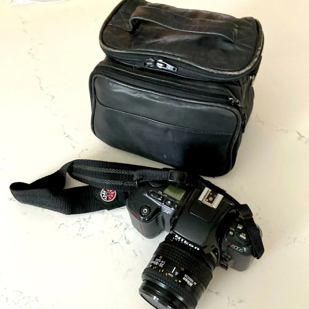 Nikon N6006 AF camera with lenses and leather bag.